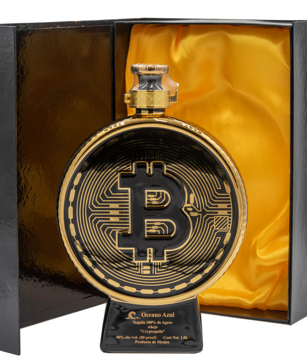 Oceano Azul Bitcoin Cryptoquila bottle displayed in its open black presentation box with gold satin lining.