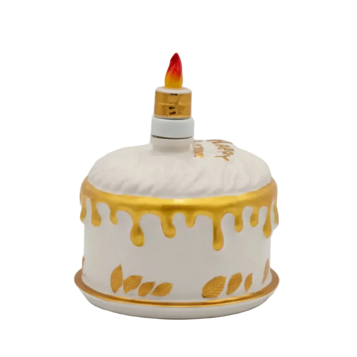 Oceano Azul Round White La Cake vodka in a white-and-gold cake-shaped bottle with candle stopper.