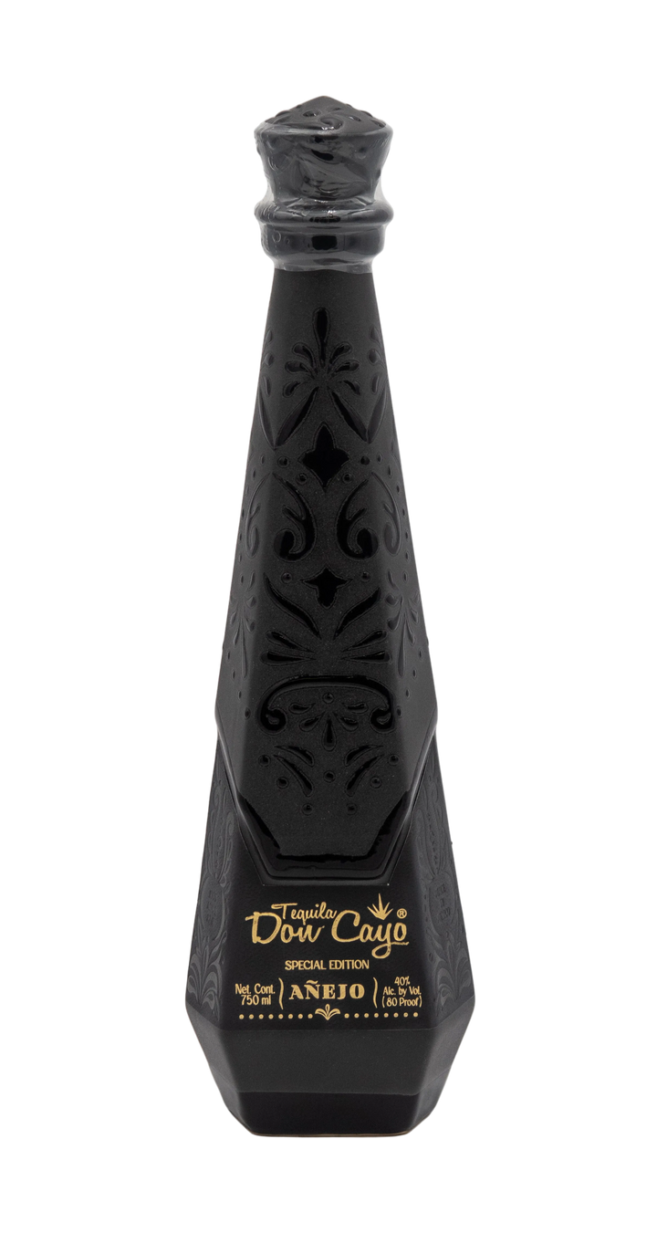 Don Cayo Añejo black ceramic tequila bottle with carved decorative patterns and gold lettering.