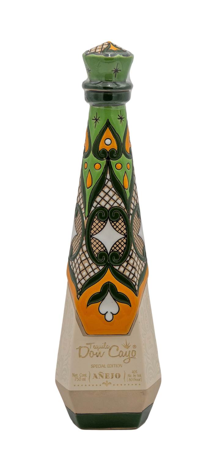 Don Cayo Añejo ceramic tequila bottle with green, yellow, and white decorative patterns.