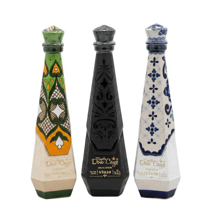 Don Cayo Añejo ceramic tequila bottles in green, black, and blue designs.
