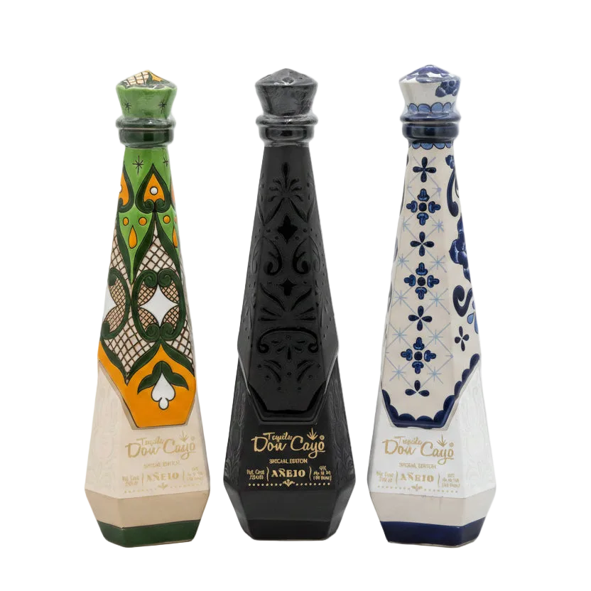 Don Cayo Añejo ceramic tequila bottles in green, black, and blue designs.