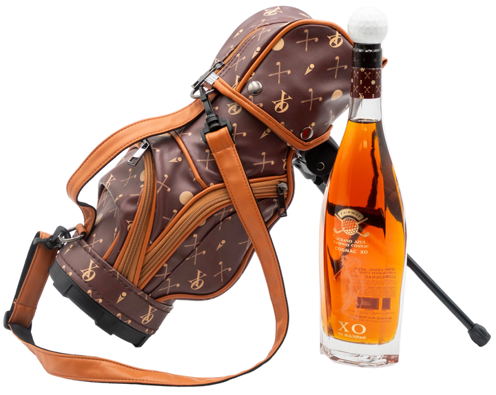 Oceano Azul Fairway Cognac XO bottle beside its patterned golf bag with stand and shoulder strap.