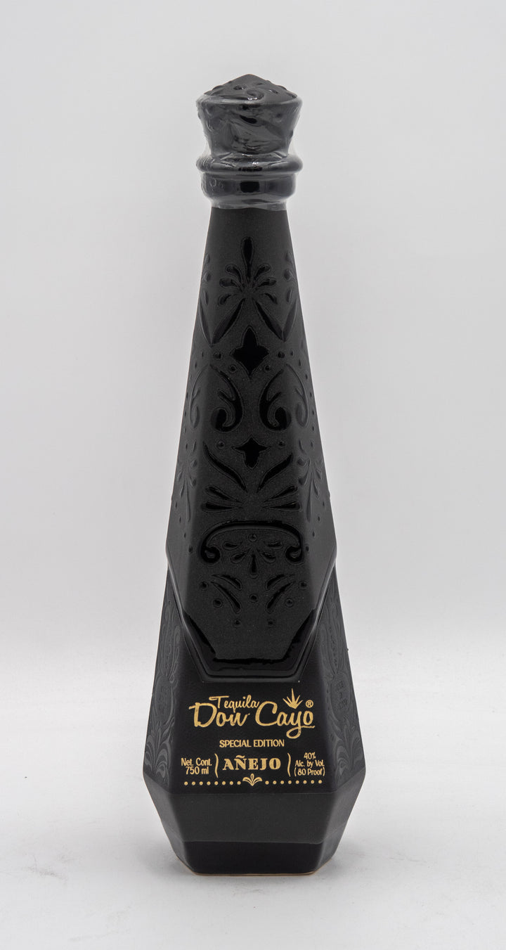Black decorative bottle with intricate designs on a white background