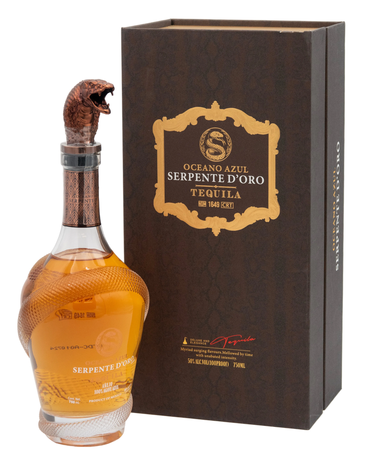 Oceano Azul Serpente D'Oro tequila bottle with sculpted snake cap beside its closed presentation box.