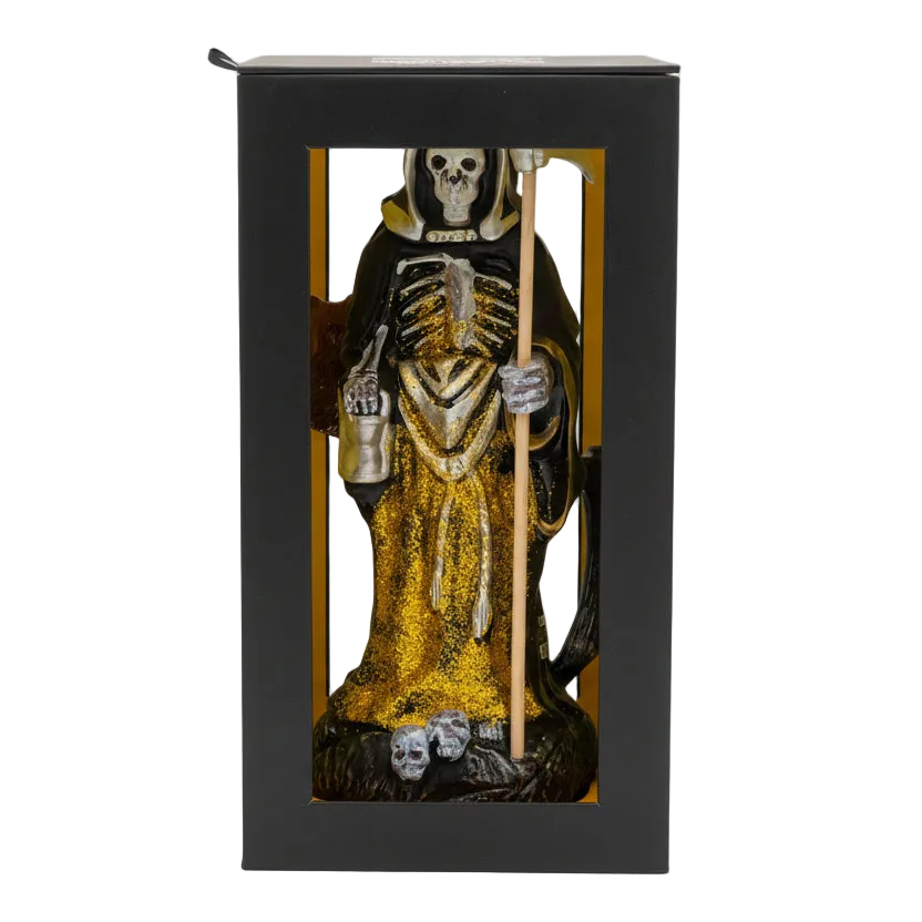 Statue of a skeleton in a robe with a staff inside a black box on a white background