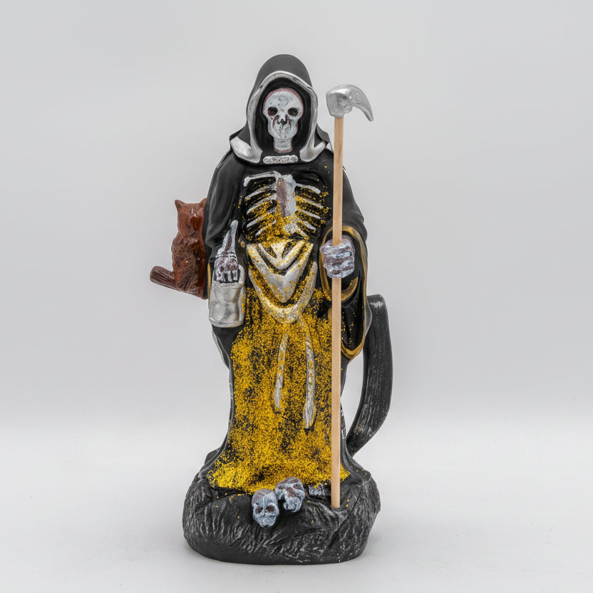 Statue of a skeleton figure with a scythe on a white background