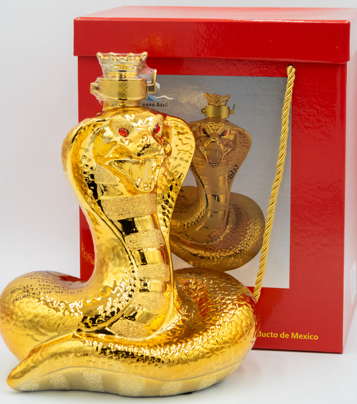 Gold snake-shaped bottle with red eyes against a red box background
