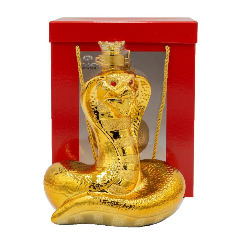 Gold snake-shaped bottle with red eyes in front of a red box on a white background