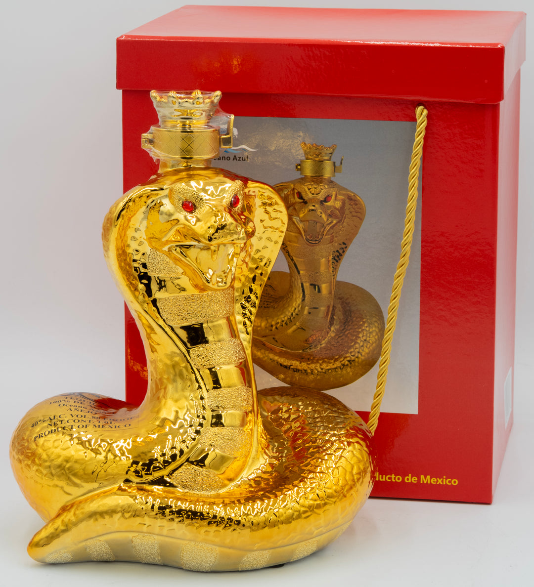 Gold snake-shaped bottle with red eyes in front of a red box on a white background