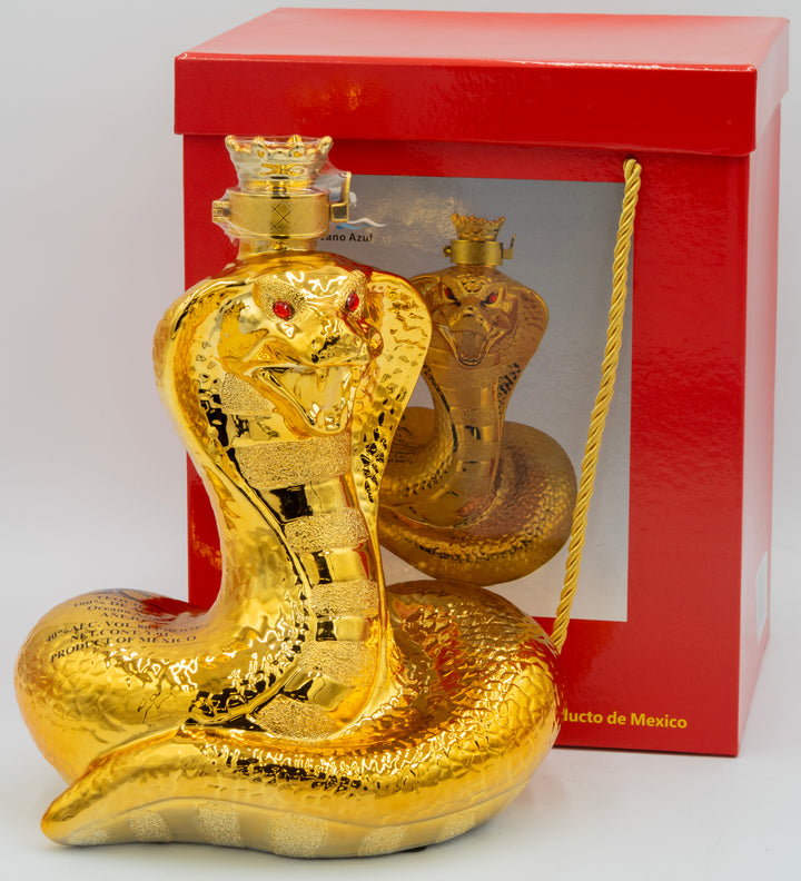 Gold snake-shaped bottle with red eyes in front of a red box on a white background