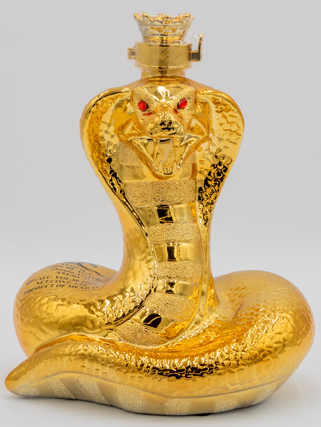 Gold snake-shaped bottle with a detailed design on a gray background