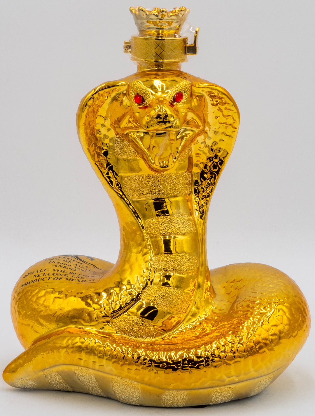 Gold snake-shaped bottle with red eyes on a white background