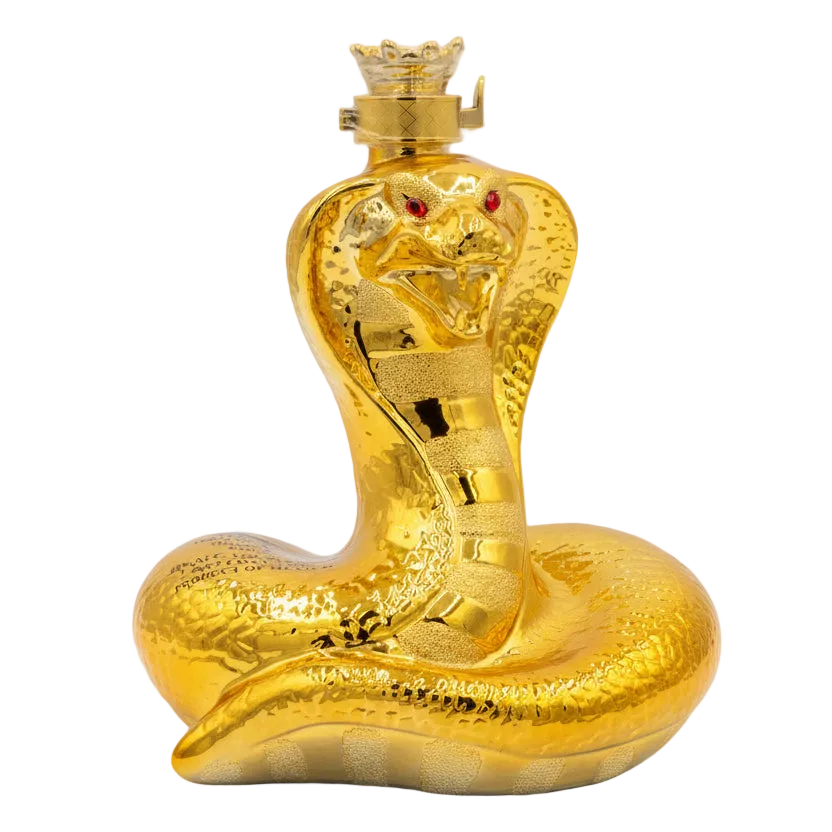 Gold snake-shaped bottle with red eyes on a white background.