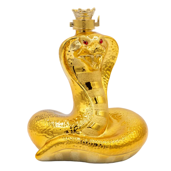 Gold snake-shaped bottle with red eyes on a white background.