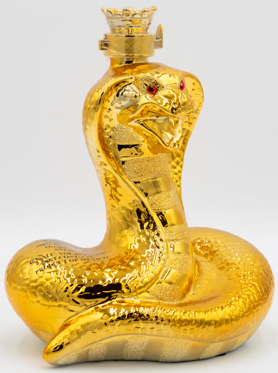 Gold snake-shaped bottle with red eyes on a white background