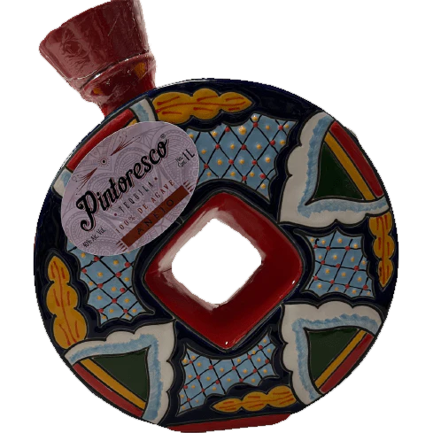 Pintoresco Añejo Tequila 1L in a multicolored decorative ceramic bottle with a red cap and diamond-shaped center opening.
