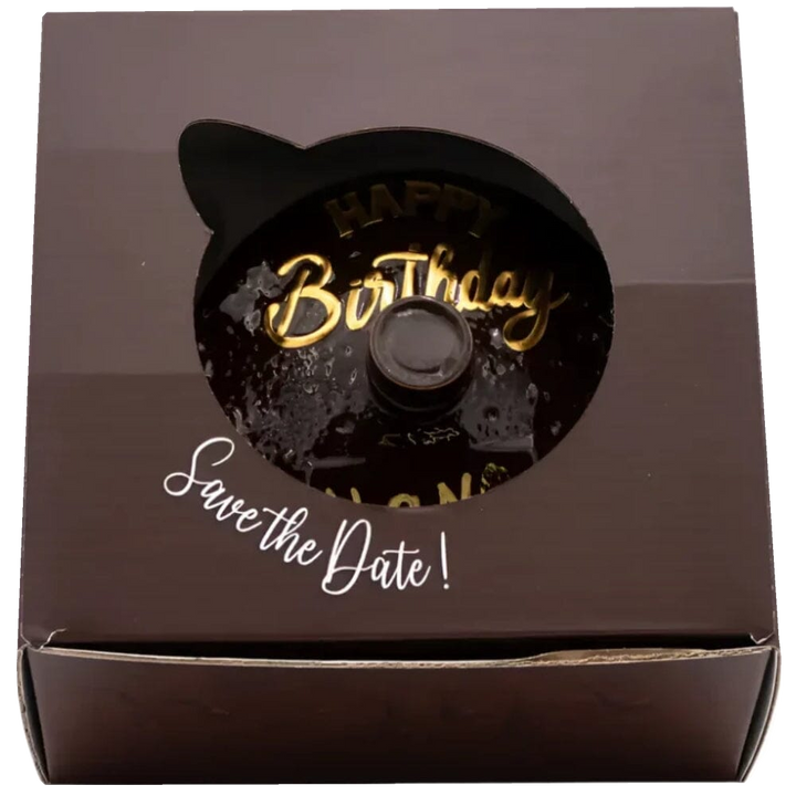 Oceano Azul Round Chocolate La Cake bottle viewed through the window of its closed presentation box.