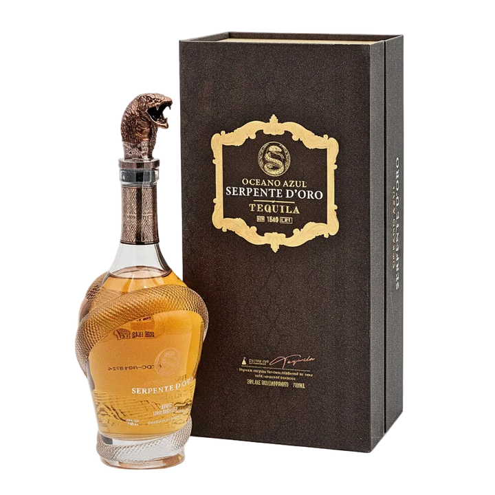 A bottle of Oceano Azul Serpente D'oro Añejo Tequila with a distinctive golden snake cap on the top, alongside its brown packaging box, displaying luxurious branding and design.