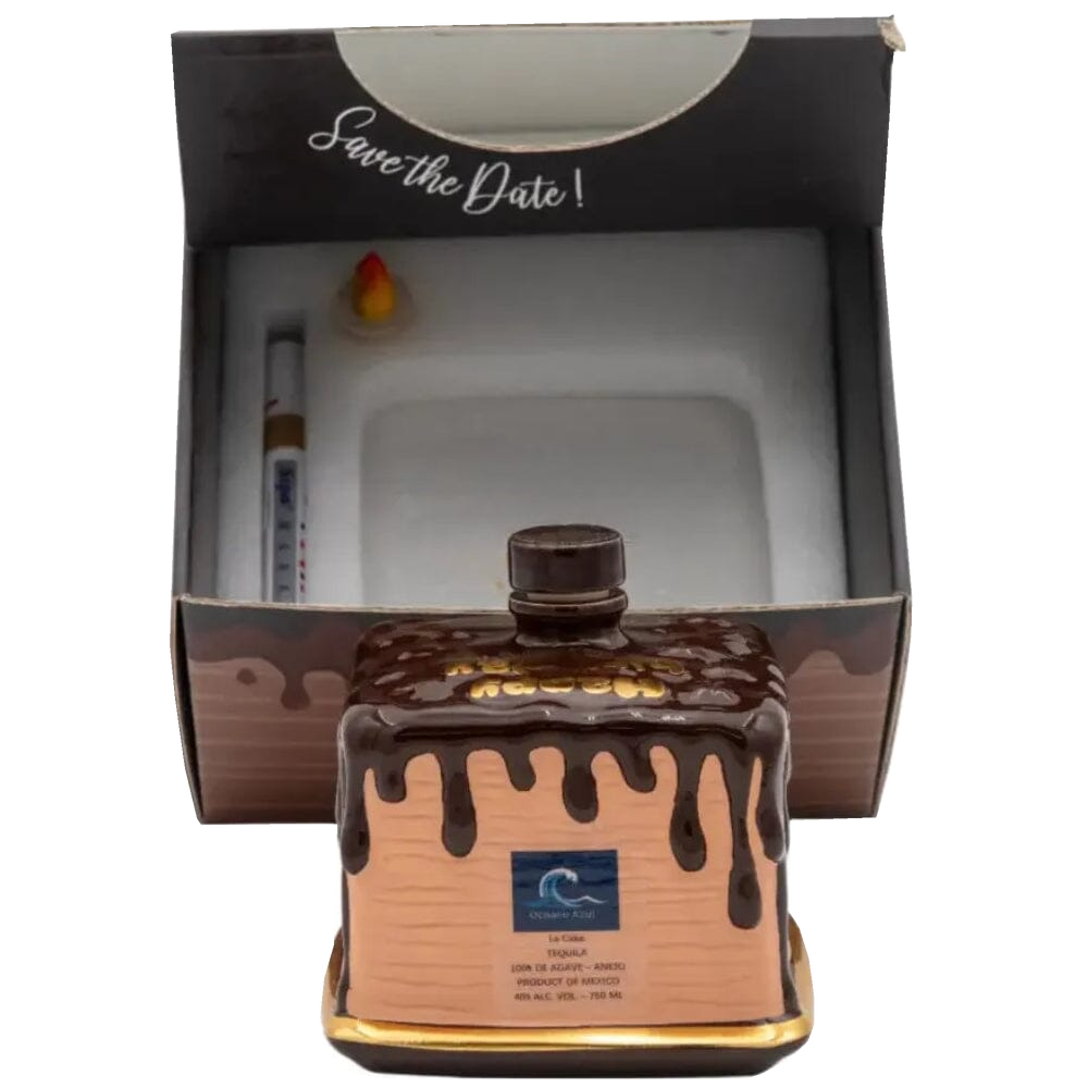 Oceano Azul square chocolate-colored La Cake bottle in front of its open presentation box with included accessories.