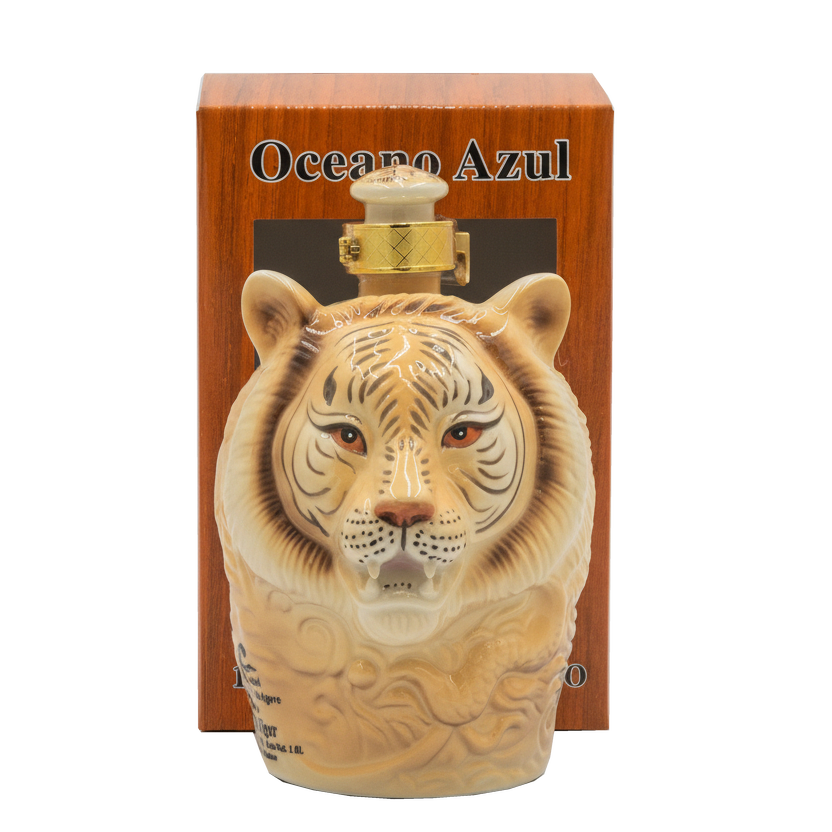 Oceano Azul White Tiger Anejo Tequila ceramic bottle displayed in front of its orange presentation box.
