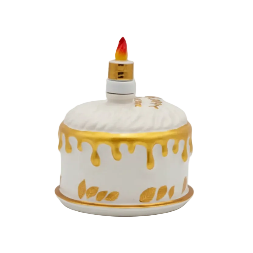 Oceano Azul round white La Cake bottle with gold decorations and candle-shaped stopper.